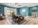 Bright dining room features a ceiling fan, table, and sliding glass door to the backyard at 1824 W State Ave, Phoenix, AZ 85021