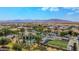 Community aerial shot showcasing pool, bocce ball courts, desert landscape, and majestic mountain views at 18259 W Buena Vista Dr, Surprise, AZ 85374