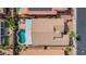 Aerial view of the backyard featuring a beautiful blue swimming pool, manicured landscaping, and patio at 18259 W Buena Vista Dr, Surprise, AZ 85374