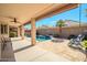 Covered patio overlooks the refreshing pool and landscaped yard, offering a perfect space for outdoor relaxation and enjoyment at 18259 W Buena Vista Dr, Surprise, AZ 85374