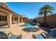 Lounge chairs offer a place to relax near the pool; backyard has desert landscaping and privacy walls for low-maintenance living at 18259 W Buena Vista Dr, Surprise, AZ 85374