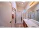 Bathroom featuring a double vanity, large mirror, and walk-in shower with tile floors at 18259 W Buena Vista Dr, Surprise, AZ 85374