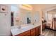 Bathroom featuring a double vanity, large mirror, and tile floors at 18259 W Buena Vista Dr, Surprise, AZ 85374