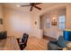 Bedroom with wood floors, ceiling fan, desk, and reading nook at 18259 W Buena Vista Dr, Surprise, AZ 85374