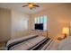 Bedroom with wood floors, a queen bed, a shuttered window, and a TV on a dresser at 18259 W Buena Vista Dr, Surprise, AZ 85374