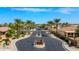 Traditions community entrance framed by towering palms, offering a picturesque welcome at 18259 W Buena Vista Dr, Surprise, AZ 85374