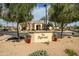 Welcoming community entrance sign amidst lush landscaping and trees at 18259 W Buena Vista Dr, Surprise, AZ 85374