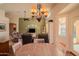 Charming dining area with a chandelier and an adjoining living space at 18259 W Buena Vista Dr, Surprise, AZ 85374