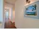 Inviting hallway with tile flooring and a decorative tropical print on the wall at 18259 W Buena Vista Dr, Surprise, AZ 85374