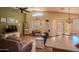 Bright living room featuring comfortable seating, ceiling fan, and a view of the patio at 18259 W Buena Vista Dr, Surprise, AZ 85374