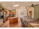 Open concept living area with a kitchen island, skylight and comfortable seating at 18259 W Buena Vista Dr, Surprise, AZ 85374