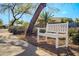 Comfortable park bench along the sidewalk with desert landscaping and tree shade at 18259 W Buena Vista Dr, Surprise, AZ 85374