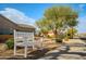 Comfortable park bench beside a sidewalk shaded by mature desert trees at 18259 W Buena Vista Dr, Surprise, AZ 85374