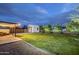 Large backyard at dusk, with a storage shed and patio featuring outdoor seating at 1849 E 2Nd Pl, Mesa, AZ 85203