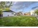 Expansive backyard featuring lush lawn, patio with pergola, and detached shed at 1849 E 2Nd Pl, Mesa, AZ 85203