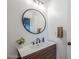 Bathroom vanity with modern sink, round mirror, and stylish accents at 1849 E 2Nd Pl, Mesa, AZ 85203