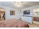 Bedroom with modern decor, TV, dresser, and stylish furnishings; attached bathroom visible at 1849 E 2Nd Pl, Mesa, AZ 85203