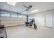 Spacious garage with an overhead door and modern epoxy floor with motorcycle parked inside at 1849 E 2Nd Pl, Mesa, AZ 85203