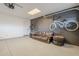 Spacious garage featuring a couch and bikes hanging on the black accent wall at 1849 E 2Nd Pl, Mesa, AZ 85203