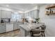 Updated kitchen featuring white cabinets, granite countertops, breakfast bar, and modern appliances at 1849 E 2Nd Pl, Mesa, AZ 85203