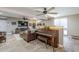 Cozy living room with wood floors, leather sofa, piano, and mounted television over fireplace at 1849 E 2Nd Pl, Mesa, AZ 85203