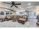 Comfortable living room with a large sectional, ceiling fan, and French doors leading to the outdoors at 1849 E 2Nd Pl, Mesa, AZ 85203