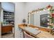 Bright vanity area with a lighted mirror and built-in wooden desk area at 1849 E 2Nd Pl, Mesa, AZ 85203