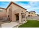 Inviting backyard with artificial turf, patio and access to home's sliding glass door at 18537 W Mariposa Dr, Surprise, AZ 85374