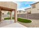 Backyard patio with artificial turf surrounded by gravel and block wall fencing at 18537 W Mariposa Dr, Surprise, AZ 85374