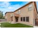 Exterior home view featuring backyard with artificial grass and covered patio area at 18537 W Mariposa Dr, Surprise, AZ 85374