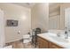 A well-lit bathroom with a single vanity, toilet, and a shower with curtain at 18537 W Mariposa Dr, Surprise, AZ 85374