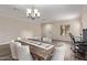 A warm and inviting dining area featuring wood floors, a wooden table, and access to the adjoining living room at 18537 W Mariposa Dr, Surprise, AZ 85374