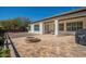 Charming backyard with a covered patio, fire pit, travertine pavers, and mountain views at 19861 S 191St St, Queen Creek, AZ 85142