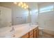 This bathroom features a dual sink vanity, large mirror, and a shower-tub combo with neutral-colored tile flooring at 19861 S 191St St, Queen Creek, AZ 85142