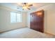 Bedroom featuring a built-in murphy bed, neutral carpet, and a window at 19861 S 191St St, Queen Creek, AZ 85142