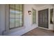 Welcoming entryway with a stylish front door and sidelight window, complemented by decorative lighting fixtures at 19861 S 191St St, Queen Creek, AZ 85142