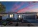 Charming single-story home featuring desert landscaping, a two-car garage, and a covered front entrance at dusk at 19861 S 191St St, Queen Creek, AZ 85142