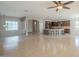 Spacious living area with tile floors, a staircase, and an open layout connecting to the kitchen and dining areas at 19861 S 191St St, Queen Creek, AZ 85142