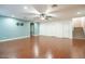 Spacious living room with hard wood floors, light blue accent wall and entry to stairs at 19861 S 191St St, Queen Creek, AZ 85142