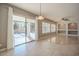 Spacious living room featuring tile floors, custom built-ins, and sliding glass doors to the outdoor living space at 19861 S 191St St, Queen Creek, AZ 85142