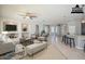 Bright, virtually staged living room with tile flooring, modern furnishings, and an open layout connecting to the kitchen at 19861 S 191St St, Queen Creek, AZ 85142