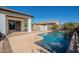 Relaxing pool in backyard offers travertine pool deck, water feature, and privacy at 19861 S 191St St, Queen Creek, AZ 85142