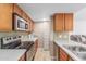 Bright kitchen area with wood floors, stainless steel appliances, and a view into the living room at 200 E Southern Ave # 173, Tempe, AZ 85282