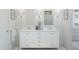 Bathroom features a double vanity with white cabinetry and white walls at 20318 W Turney Ave, Buckeye, AZ 85396