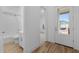 Bright bathroom featuring wood floors, shower-tub combo, and white subway tile at 20318 W Turney Ave, Buckeye, AZ 85396