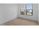 Simple bedroom featuring carpet flooring, a view of the street, and neutral color scheme at 20318 W Turney Ave, Buckeye, AZ 85396