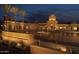 Elegant Verrado Golf Club clubhouse illuminated at twilight with a grand entrance and water feature at 20318 W Turney Ave, Buckeye, AZ 85396