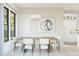 Cozy dining area with a wood table, modern chandelier, and comfortable chairs, adjacent to the bright kitchen at 20318 W Turney Ave, Buckeye, AZ 85396