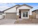 Beautiful single-story home featuring a two car garage, covered porch, and stone accents at 20318 W Turney Ave, Buckeye, AZ 85396