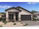 Charming single-story home with a neutral color palette, two-car garage, desert landscaping and covered front porch at 20318 W Turney Ave, Buckeye, AZ 85396